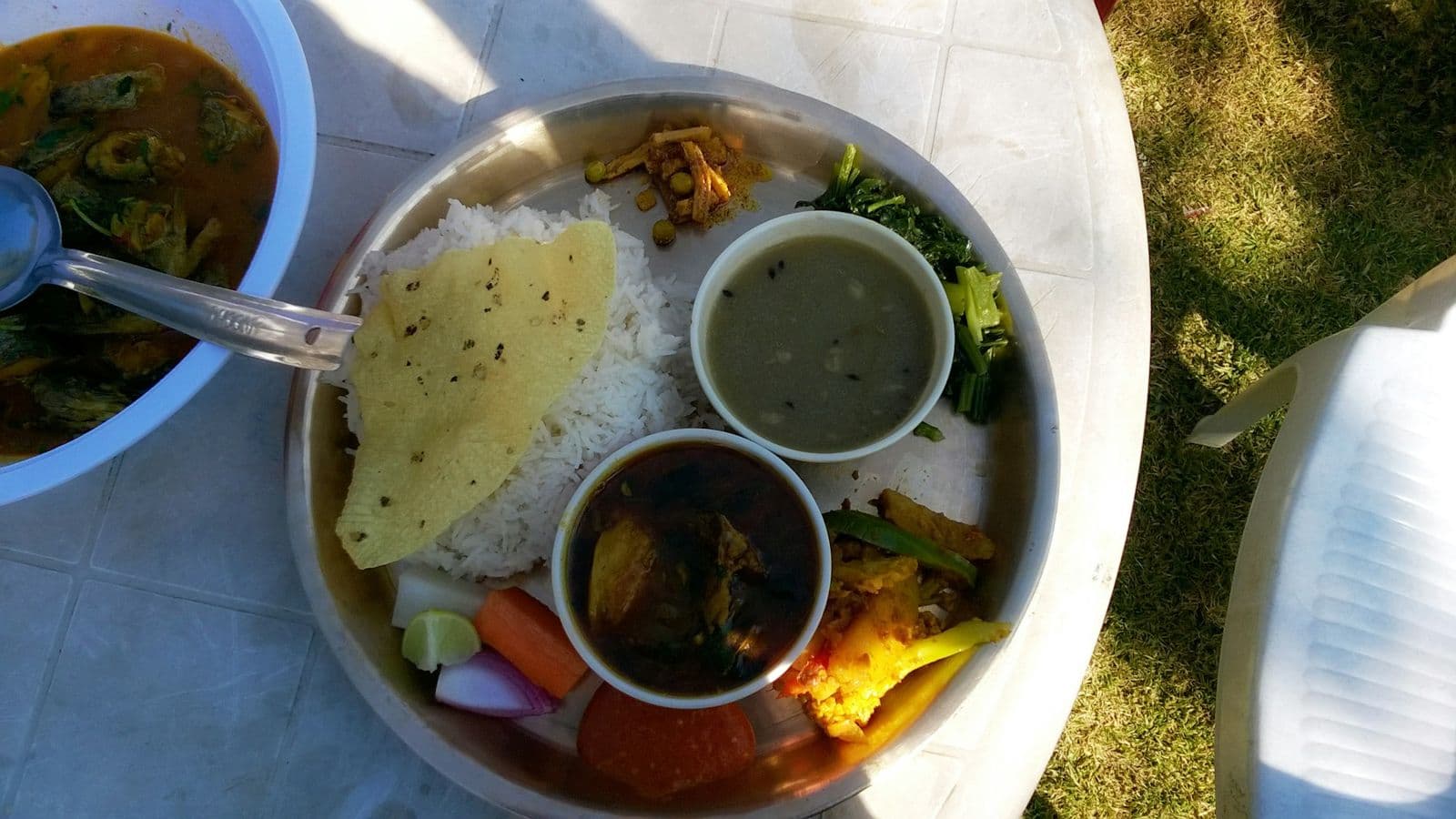 Plate of Nepali dal bhat with curries and pickles