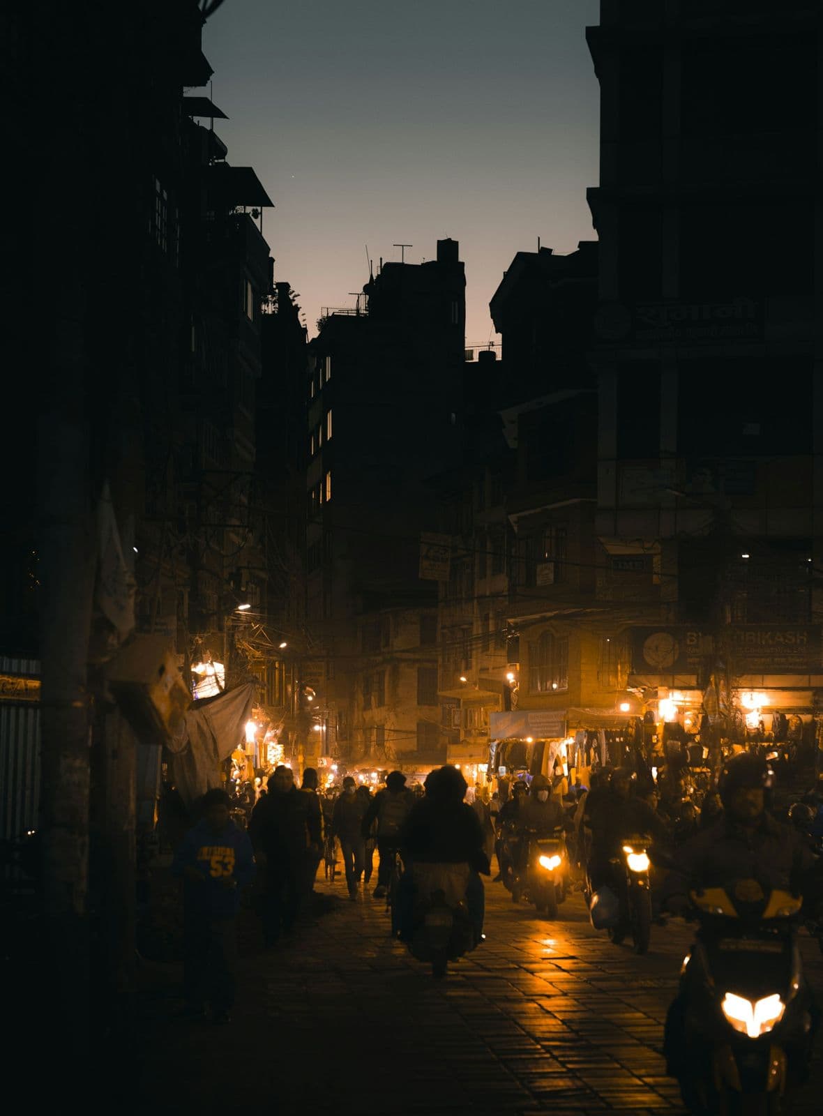 Kathmandu street at night with scooters