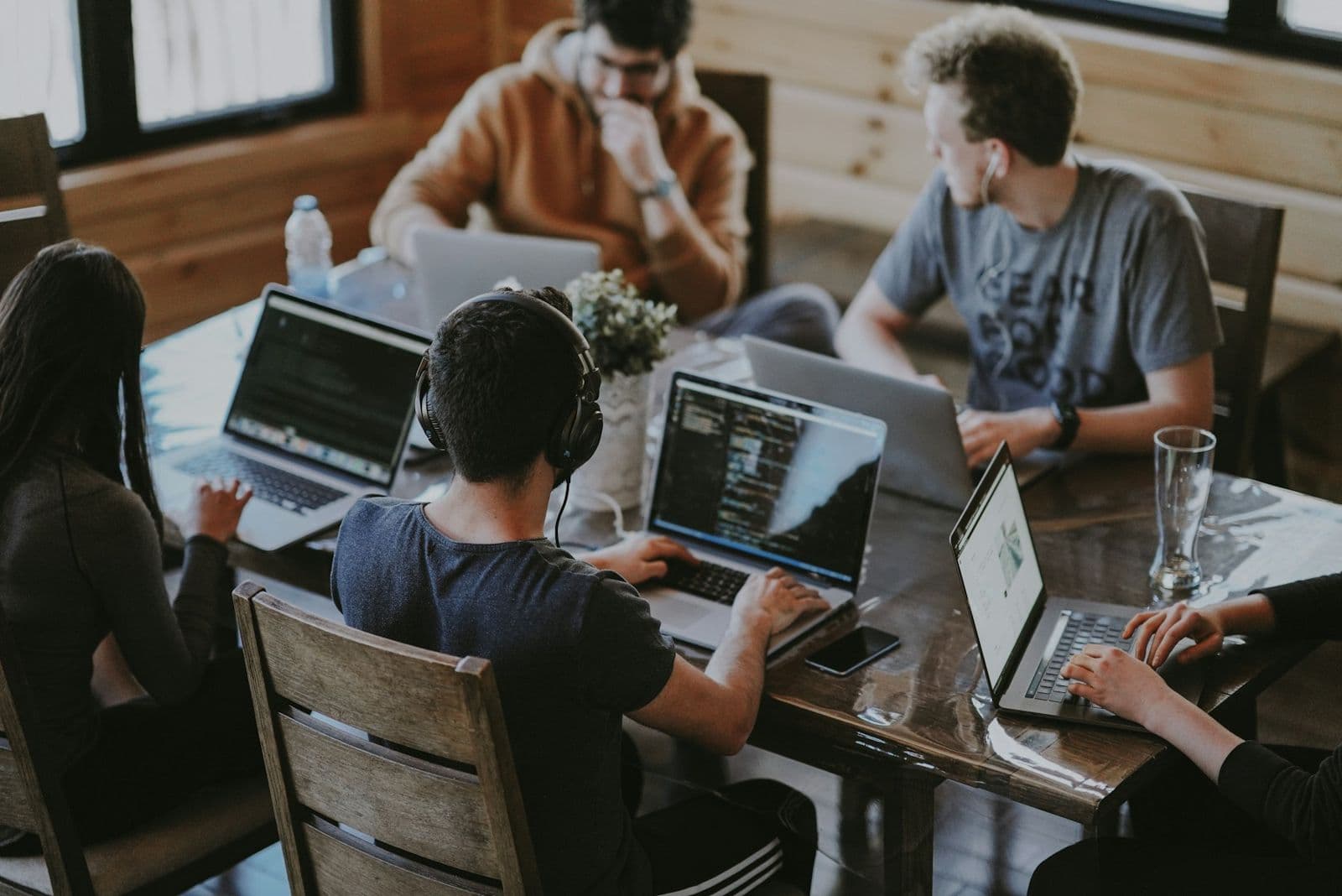 People working on laptops around a table